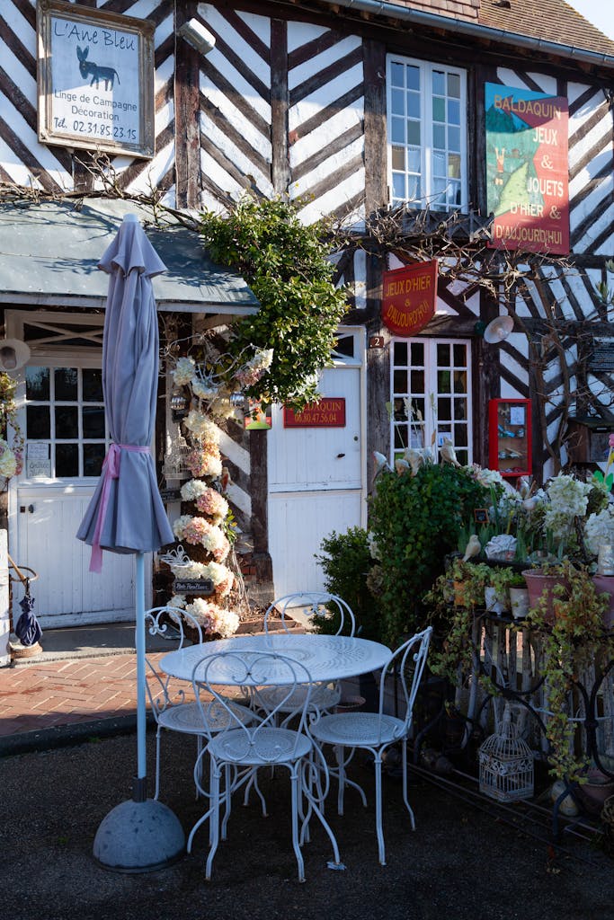 Discover the quaint charm of a café in Beuvron-en-Auge, France, showcasing rustic architecture.
